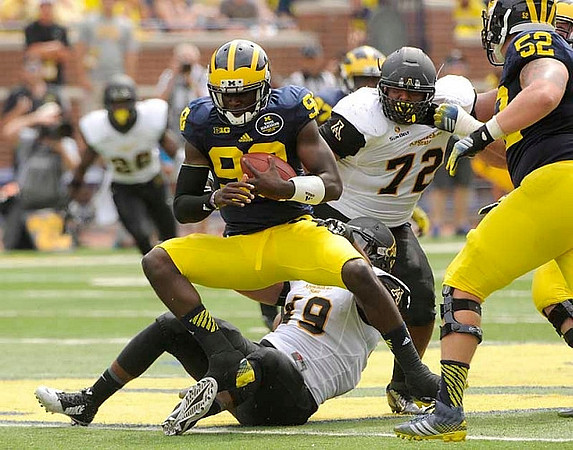 Devin Gardner (98) and Mason Cole (52)