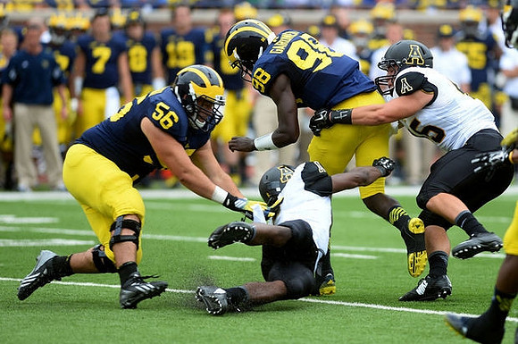 Joey Burzynski (56) and Devin Gardner (98)