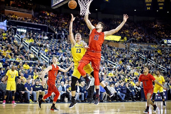 Muhammad-Ali Abdur-Rahkman (12), Moritz Wagner (13), and Zavier Simpson (3)