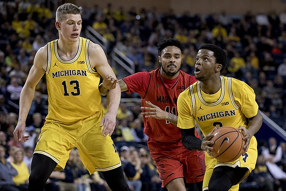 Moritz Wagner (13) and Zavier Simpson (3)