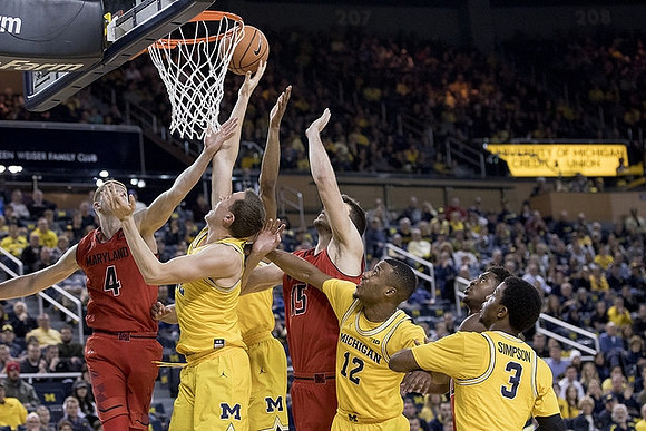 Duncan Robinson (22), Muhammad-Ali Abdur-Rahkman (12), and Zavier Simpson (3)