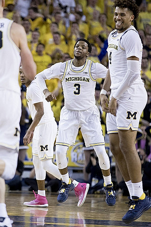 Zavier Simpson (3) and Isaiah Livers (4)