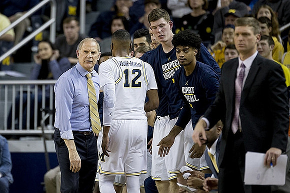 John Beilein, Muhammad-Ali Abdur-Rahkman (12), Jon Teske (15), Ibi Watson (23), and Luke Yaklich