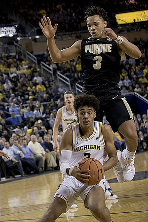 Moritz Wagner (13) and Jordan Poole (2)