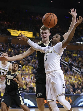 Moritz Wagner (13) and Zavier Simpson (3)
