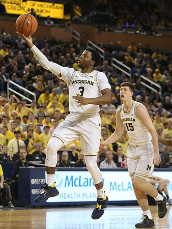 Zavier Simpson (3) and Jon Teske (15)