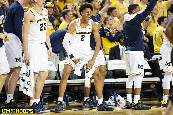 Duncan Robinson (22), Jordan Poole (2), and Jaaron Simmons (5)