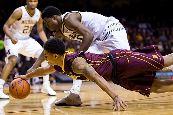 Zak Irvin (21) and Derrick Walton Jr. (10)