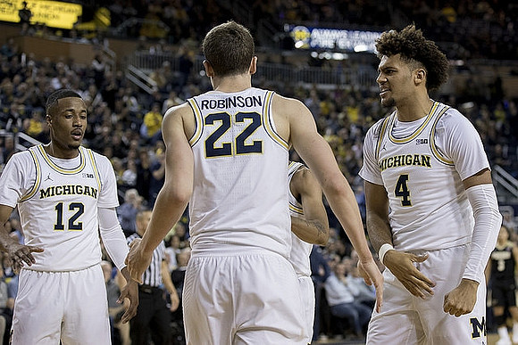 Muhammad-Ali Abdur-Rahkman (12), Duncan Robinson (22), and Isaiah Livers (4)