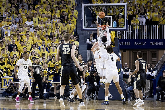 Muhammad-Ali Abdur-Rahkman (12), Moritz Wagner (13), Zavier Simpson (3), and Isaiah Livers (4)