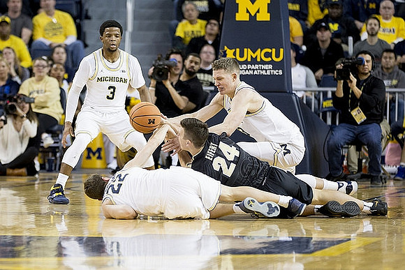 Zavier Simpson (3), Duncan Robinson (22), and Moritz Wagner (13)