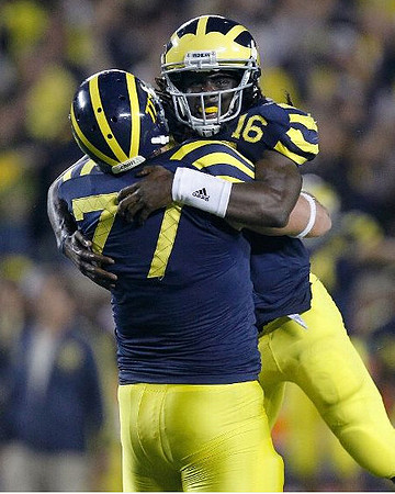 Taylor Lewan (77) and Denard Robinson (16)