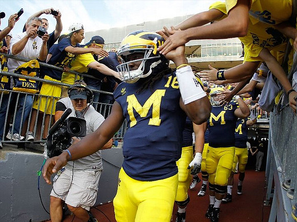 Denard Robinson (16) and Rocko Khoury (63)