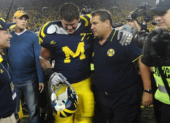 Taylor Lewan (77) and Brady Hoke