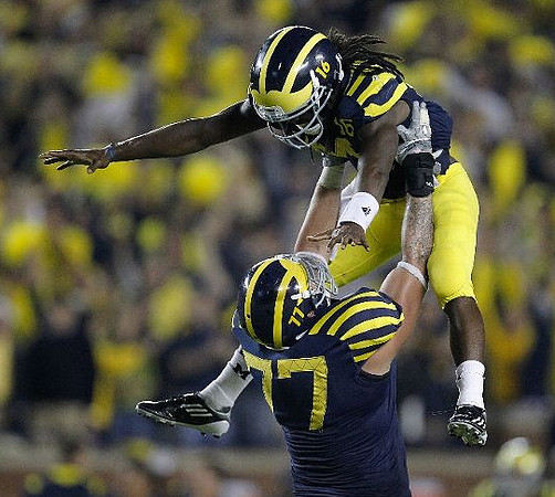 Taylor Lewan (77) and Denard Robinson (16)