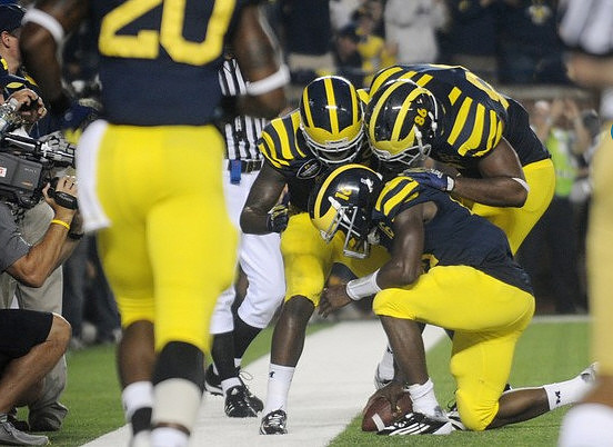 Denard Robinson (16), Junior Hemingway (21), and Kevin Koger (86)