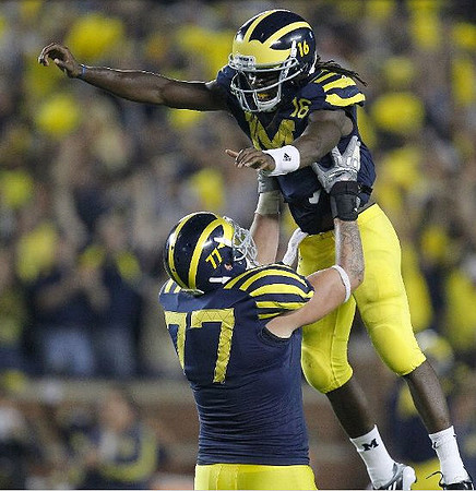 Taylor Lewan (77) and Denard Robinson (16)