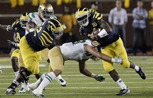 Ricky Barnum (52) and Denard Robinson (16)