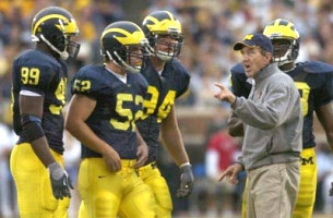 Lloyd Carr, Pierre Woods (92), Ross Mann (52), and Pat Massey (94)