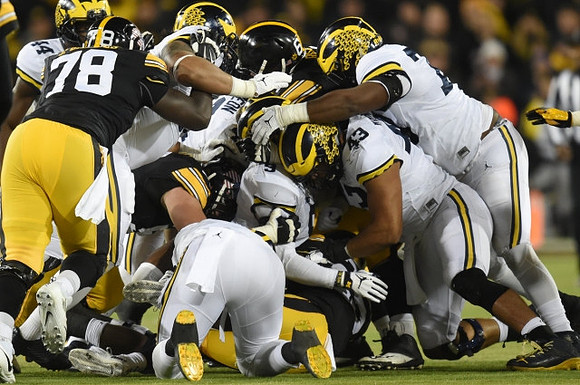 Delano Hill (44), Ben Gedeon (42), Mike McCray (9), Chris Wormley (43), and Maurice Hurst (73)