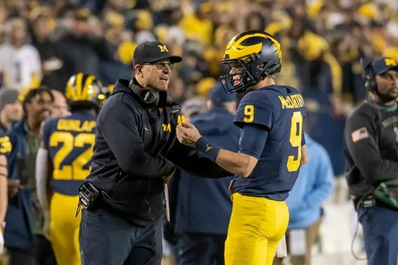 Tavierre Dunlap (22), Jim Harbaugh, and J.J. McCarthy (9)