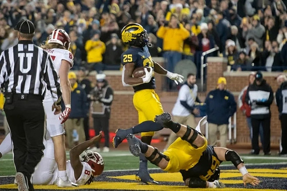 Hassan Haskins (25) and Andrew Vastardis (68)