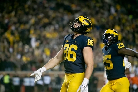 Luke Schoonmaker (86) and Hassan Haskins (25)
