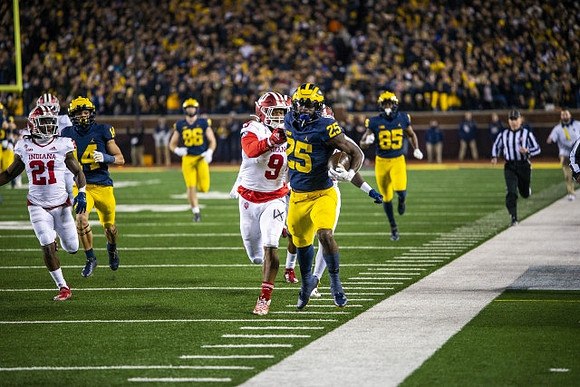 Roman Wilson (14), Luke Schoonmaker (86), Hassan Haskins (25), and Daylen Baldwin (85)