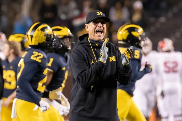 Tavierre Dunlap (22), Andrel Anthony (1), Jim Harbaugh, and Mike Sainristil (5)