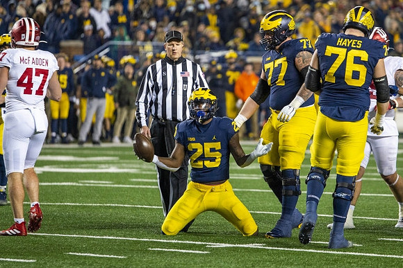 Hassan Haskins (25), Trevor Keegan (77), and Ryan Hayes (76)