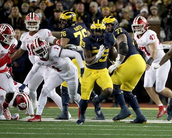 Ryan Hayes (76), Hassan Haskins (25), and Trevor Keegan (77)