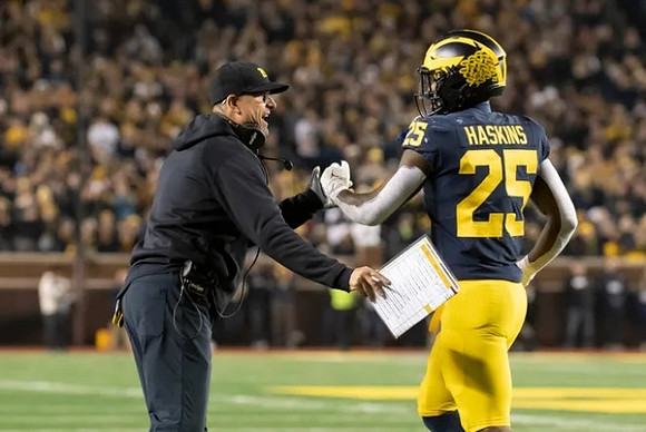 Jim Harbaugh and Hassan Haskins (25)