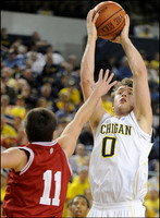 Zack Novak (0) and Darius Morris (4)