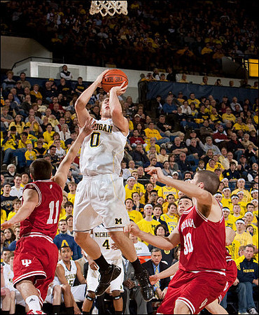 Zack Novak (0) and Darius Morris (4)