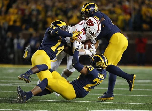Josh Metellus (14), Tyree Kinnel (23), and Khaleke Hudson (7)