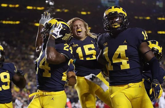 Kwity Paye (19), Lavert Hill (24), Chase Winovich (15), and Josh Metellus (14)