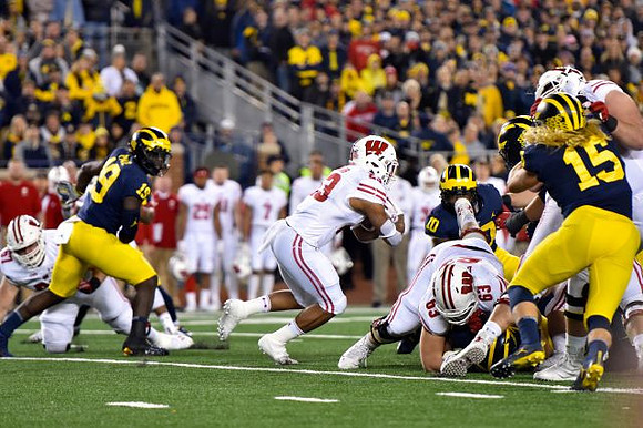 Kwity Paye (19), Devin Bush (10), and Chase Winovich (15)