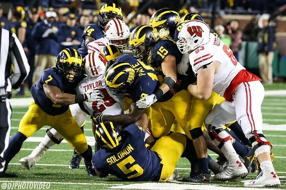 Khaleke Hudson (7), Aubrey Solomon (5), Josh Metellus (14), Kwity Paye (19), and Chase Winovich (15)
