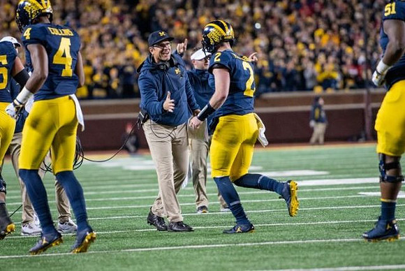 Nico Collins (4), Jim Harbaugh, Shea Patterson (2), and Cesar Ruiz (51)