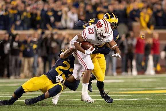 Tyree Kinnel (23) and Josh Metellus (14)