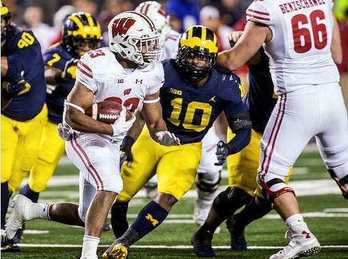 Bryan Mone (90), Khaleke Hudson (7), and Devin Bush (10)