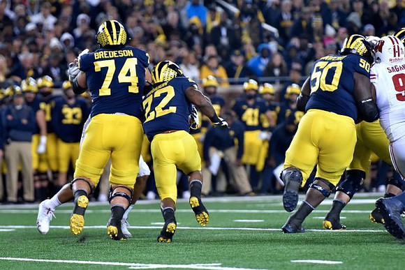 Ben Bredeson (74), Karan Higdon (22), and Michael Onwenu (50)
