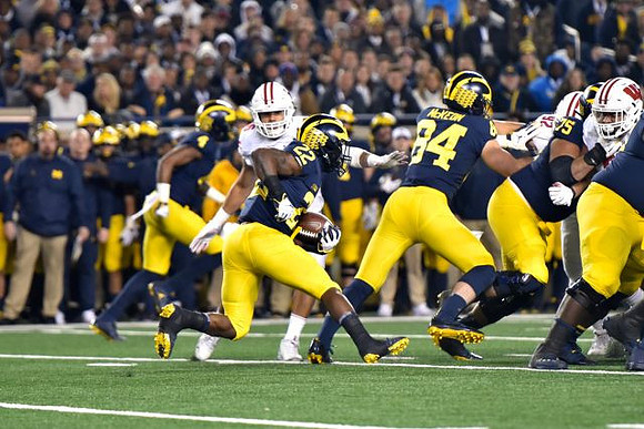 Nico Collins (4), Karan Higdon (22), Sean McKeon (84), and Jon Runyan Jr. (75)
