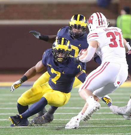 Khaleke Hudson (7) and Devin Bush (10)