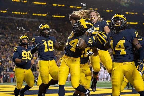 Bryan Mone (90), Kwity Paye (19), Lavert Hill (24), Carlo Kemp (2), Chase Winovich (15), and Josh Metellus (14)