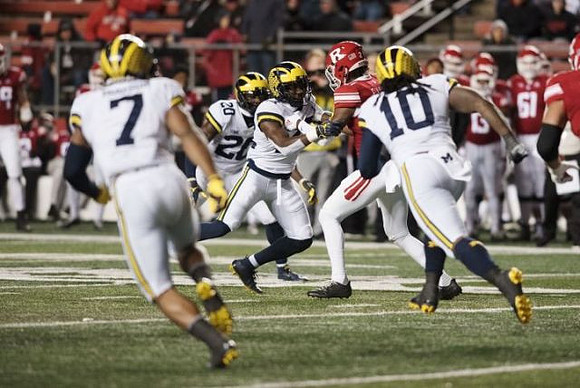 Khaleke Hudson (7), Brad Hawkins (20), and Devin Bush (10)