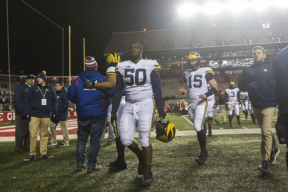Michael Onwenu (50) and Chase Winovich (15)