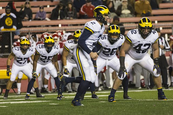 Joe Hewlett (27), Hassan Haskins (25), Tru Wilson (13), Shea Patterson (2), and Ben Mason (42)