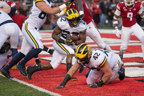 Sean McKeon (84), Karan Higdon (22), and Ben Mason (42)