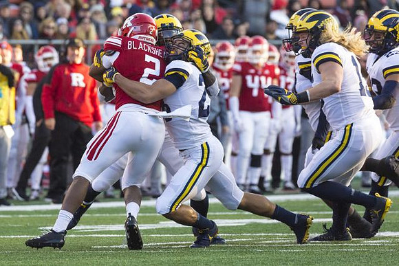Brandon Watson (28), Chase Winovich (15), and David Long (22)